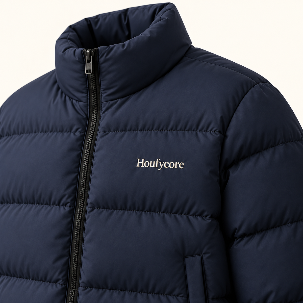 Close-up of the Midnight Navy Northline puffer jacket, showing the stand collar, quilted panels, zipper and Houfycore chest embroidery.