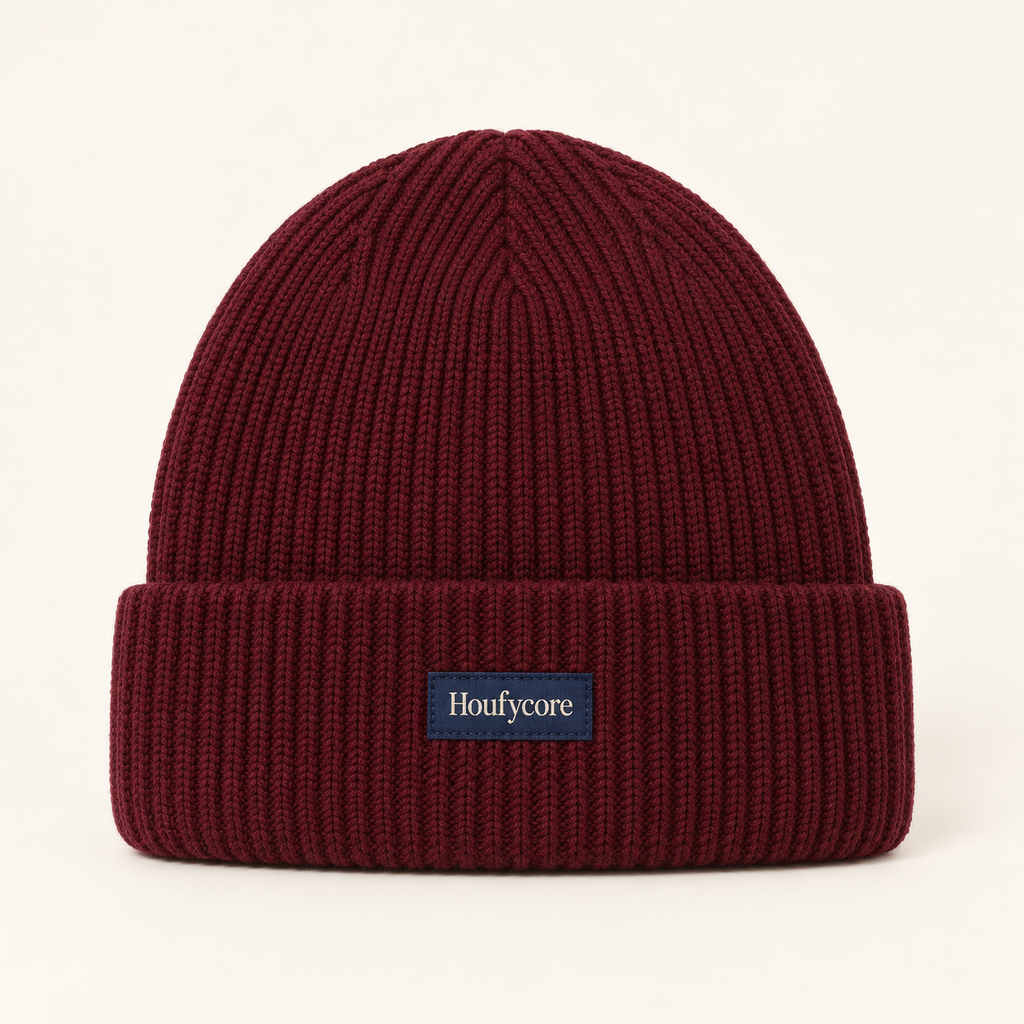 Houfycore Solstice knit beanie in Burgundy, front view with folded cuff and centered navy brand patch.