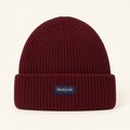Houfycore Solstice knit beanie in Burgundy, front view with folded cuff and centered navy brand patch.